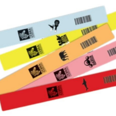 Assortment of Zebra Z-Band Splash wristbands in vibrant colours including blue, yellow, orange, pink, and red, featuring barcodes and themed icons for waterproof and durable identification in events or healthcare.