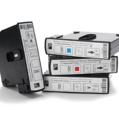Stack of Zebra Z-Band Fun wristband cartridges, designed for use with Zebra HC100 and ZD510-HC printers, featuring antimicrobial coating and vibrant colour options for secure patient or event identification.