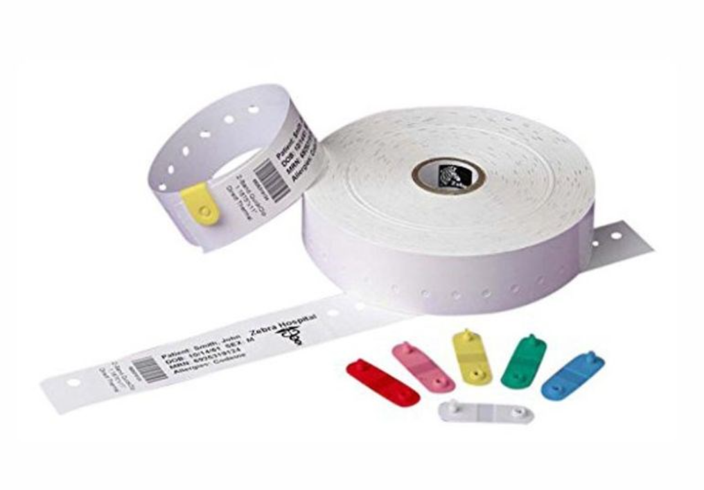 Zebra Z-Band QuickClip white pediatric wristbands on a roll, featuring perforated wristbands with printable patient details and coloured clip fasteners for secure and efficient patient identification.